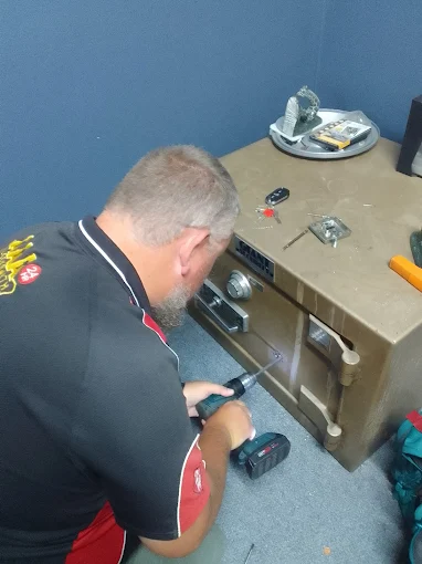 AAA Locksmiths technician working on the lock of a safe