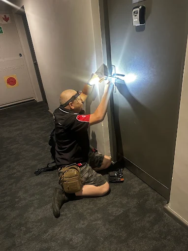 AAA Locksmiths technician fitting a lock at an apartment door