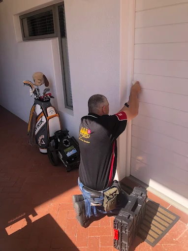AAA Locksmiths technician working on a residential door lock